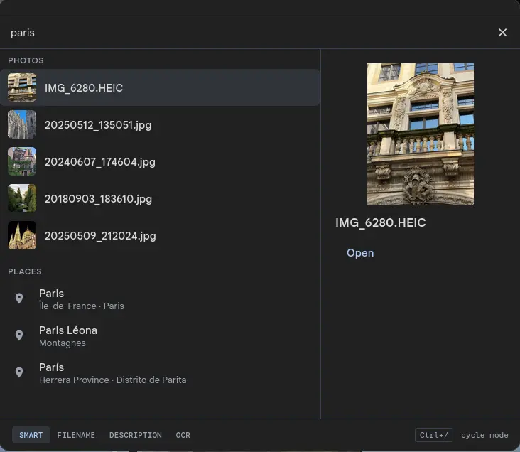 Search palette with 'paris' typed into the input, listing five matching photos with thumbnails on the left and three location matches (Paris in Île-de-France, Paris Léona, Paris in Herrera Province), with a Parisian building thumbnail in the preview pane on the right