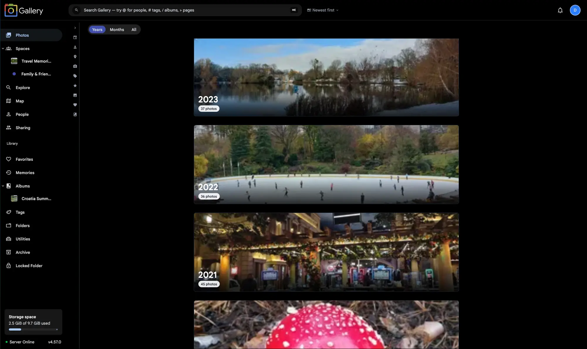 Gallery Photos timeline in Years mode showing full-width year cards for 2023, 2022, and 2021, each with a cover photo and photo count badge, and the Years / Months / All switcher visible in the top-left